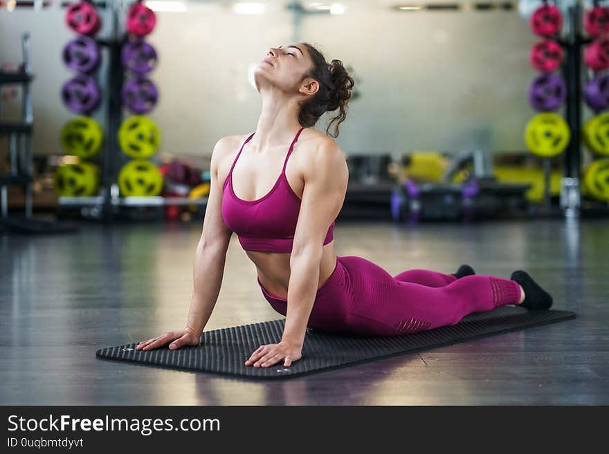 Young woman Doing Stretching Exercises on a yoga mat