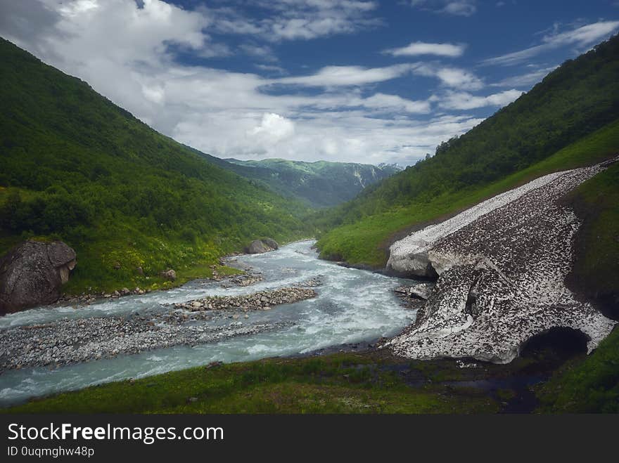 Fast Mountain River Flows Near Old Glacier After Rain