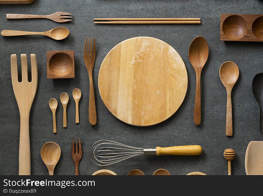 Kitchen utensils for cooking on the wooden black table, food prepare concept, top view