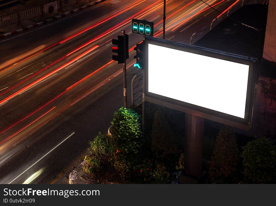 Large billboards on the street at night, with beautiful street lights.