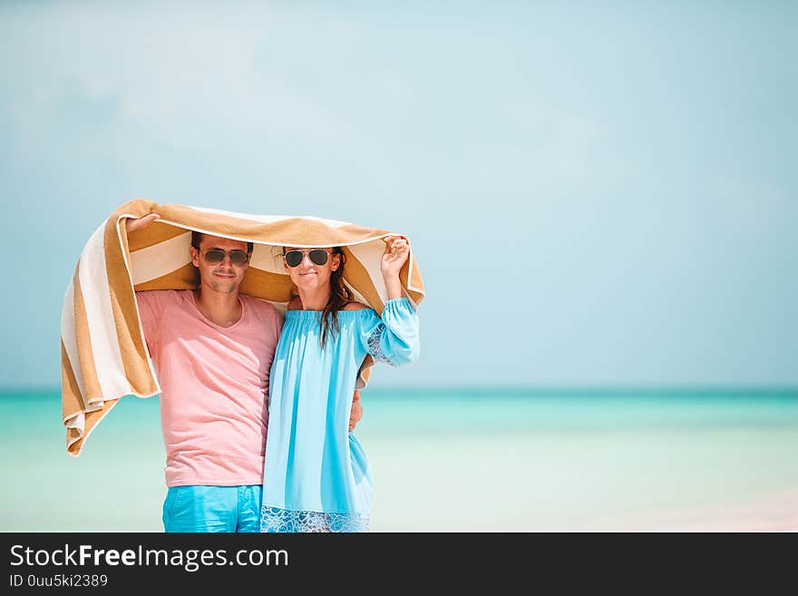 Young happy family during tropical beach vacation