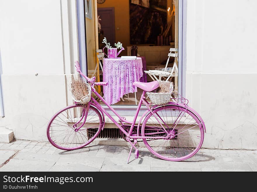 Vintage purple bicycle as decoration near cafe