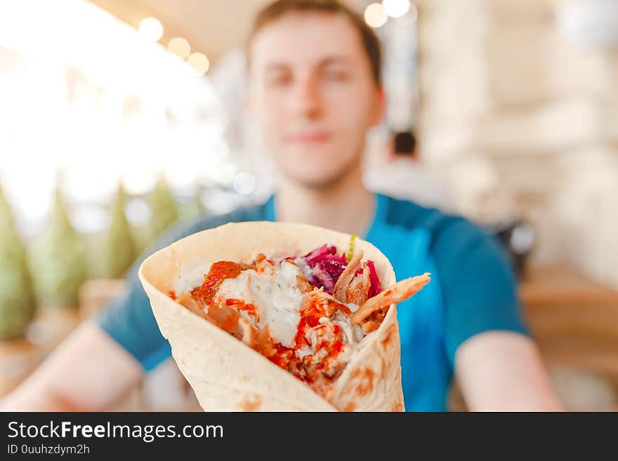 Man eating Doner Kebap its a midlle eastern fast food cuisine