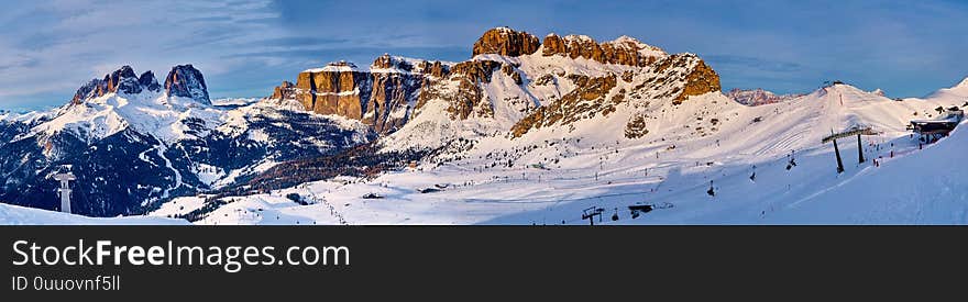 Beautiful panoramic view to the Sellaronda - the largest ski carousel in Europe - skiing the four most famous passes in the Dolomites, Italy; extraordinary snowy peaks of the dolomites, southern alps