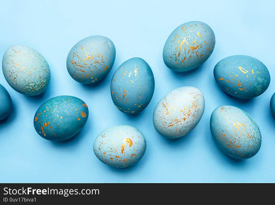 Easter background of eggs painted in blue color. Flat lay, top view.