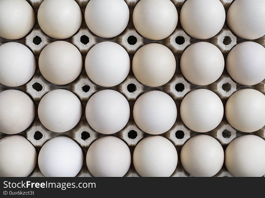 Fresh organic eggs in a carton on a wooden table