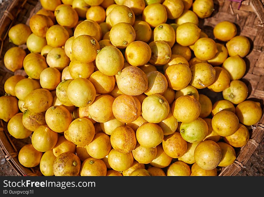 A basket full of yellow limes on sale at Zegyo market, Mandalay, Myanmar. A basket full of yellow limes on sale at Zegyo market, Mandalay, Myanmar.