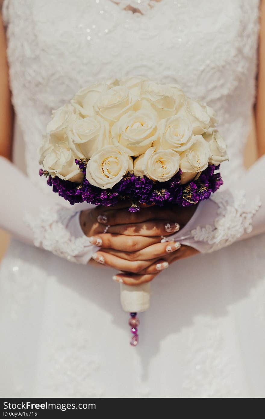 Bride holding bouquet in hands beautiful white