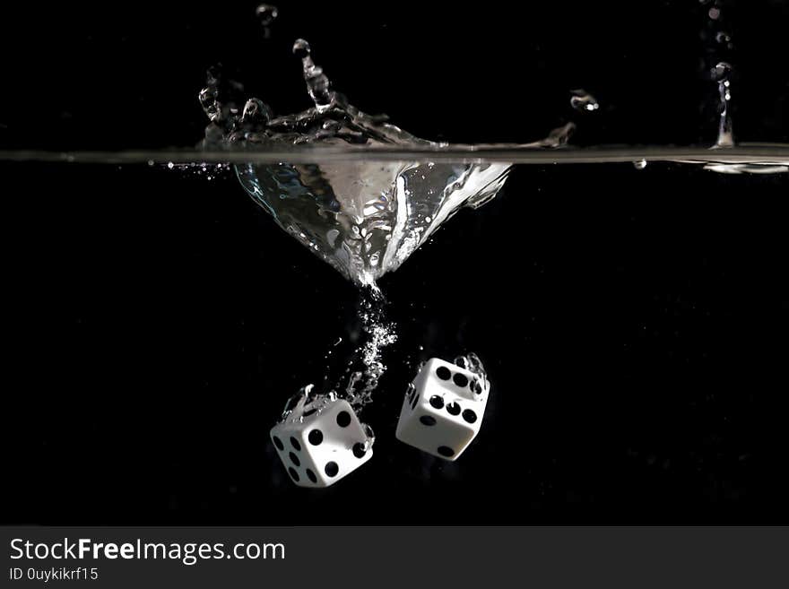 Dice splashing into a tank of water. Dice splashing into a tank of water