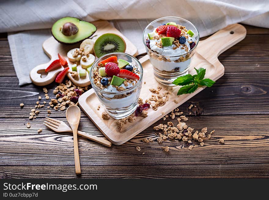Greek Yogurt homemade with berries, avocado, banana and granora. It`s healty menu and low calories for people who diet. the high quality picture for artwork and graphic design