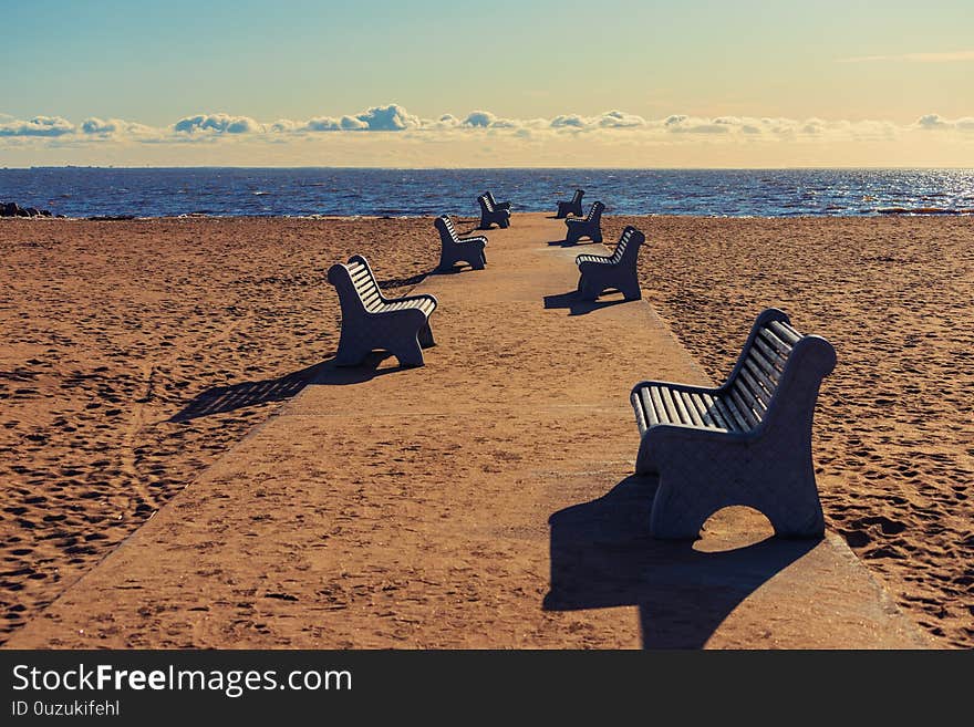 Benches on the road to the beach on a sunny winter day