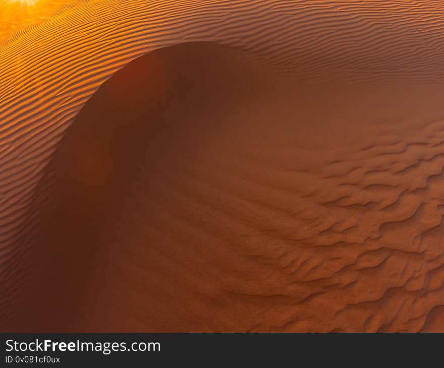 Waves of sand texture. Dunes of the desert at sunset. Beautiful structures of sandy barkhans. Waves of sand texture. Dunes of the desert at sunset. Beautiful structures of sandy barkhans.