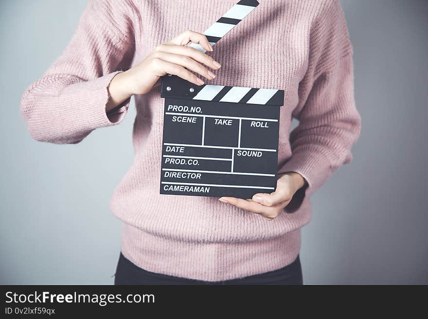 Woman hand movie sign on grey background