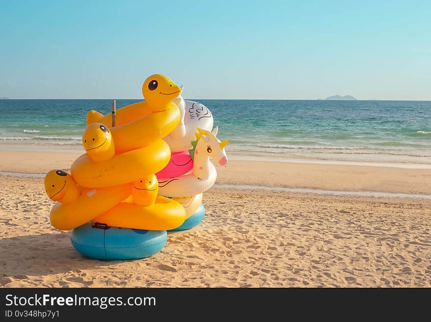 Tropical beach background. Inflatable ring on sandy beach. Background of travel in summer season