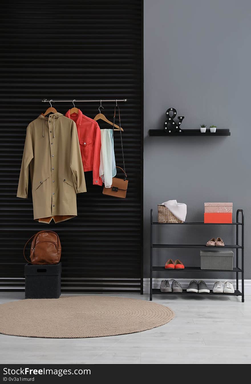 Hallway interior with stylish furniture, clothes and accessories