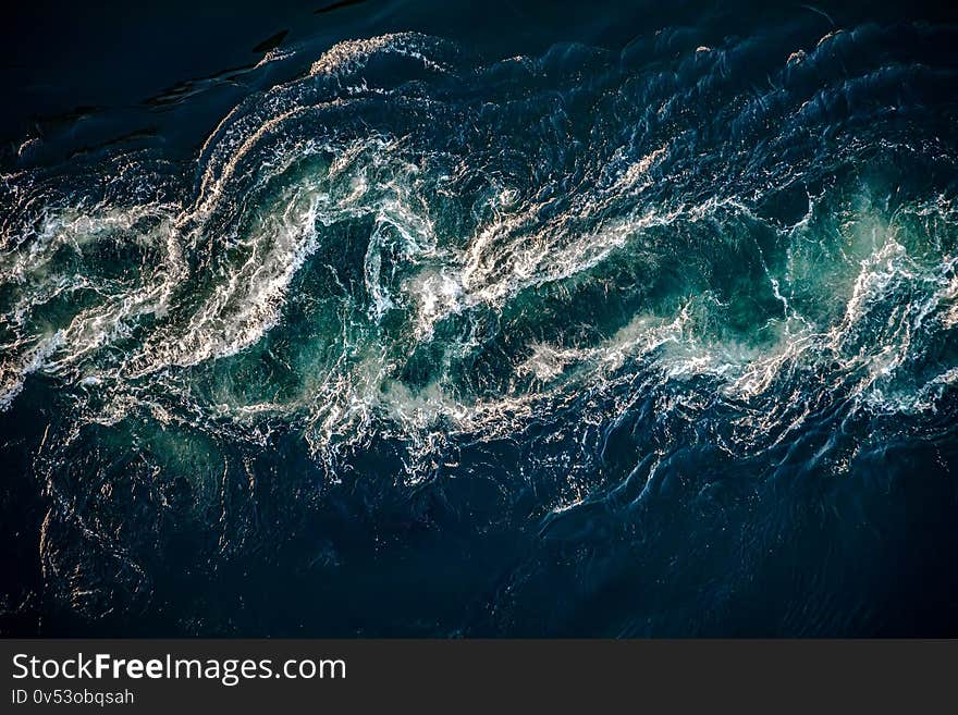 Abstract background. Waves of water of the river and the sea meet each other during high tide and low tide. Whirlpools of the maelstrom of Saltstraumen, Nordland, Norway