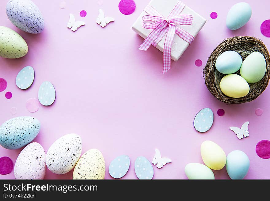 Easter eggs and gift box  on pastel pink background. Greeting for Easter.  Top view, flat lay. Easter eggs and gift box  on pastel pink background. Greeting for Easter.  Top view, flat lay