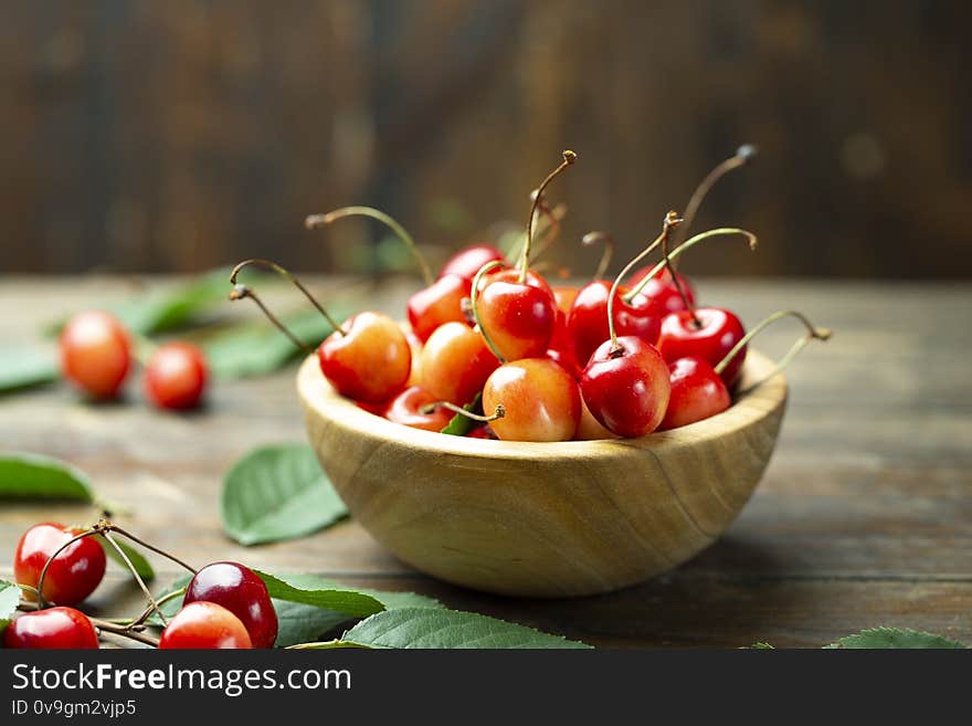 Sweet cherry in a wood plate. Fresh fruits