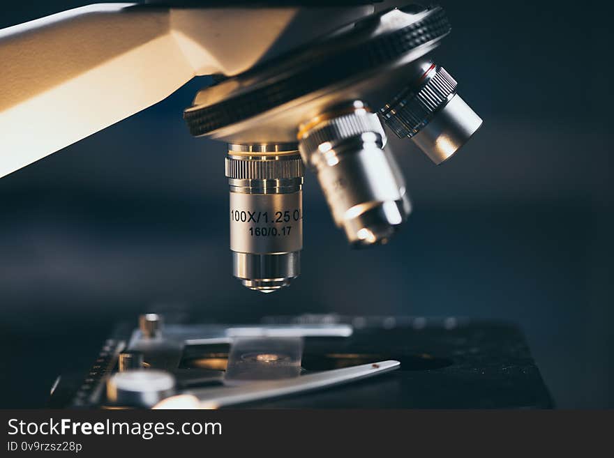 Close-up shot of microscope with metal lens at laboratory