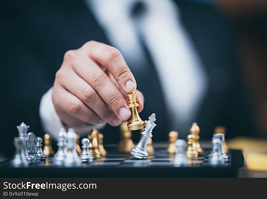 Hand of businessman moving chess figure in competition success play. strategy, management or leadership concept