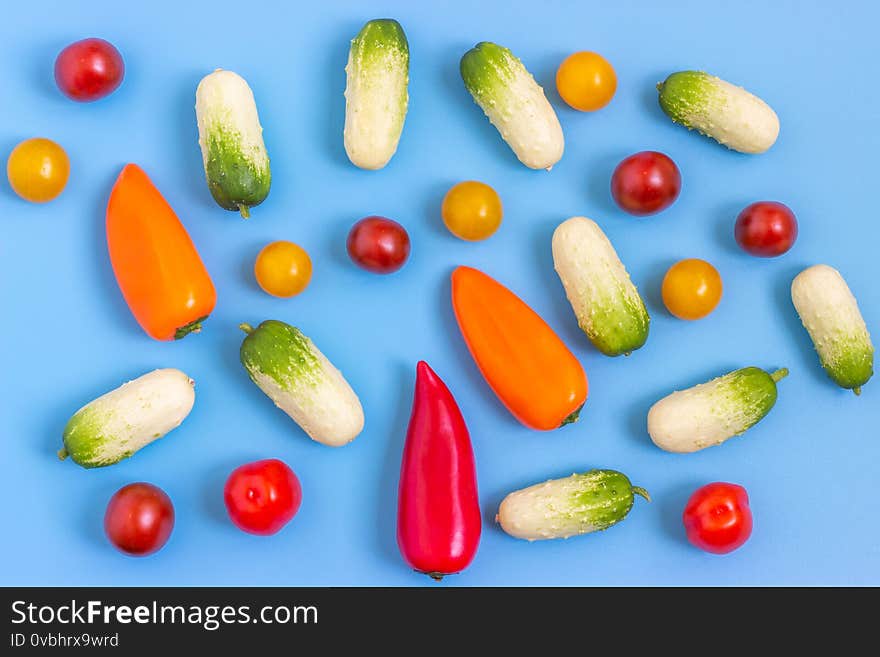 Set fresh vegetables, cucumber, tomatoes, peppers on a blue background.  Healthy food concept. Flat lay, top view