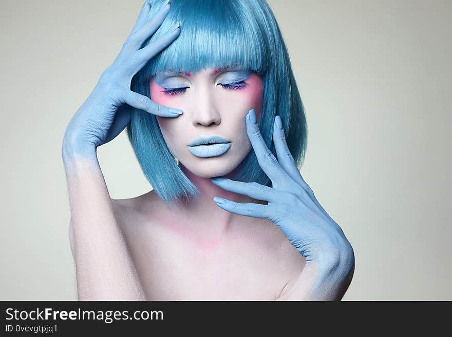 Beautiful girl with blue hair, hands and art make-up