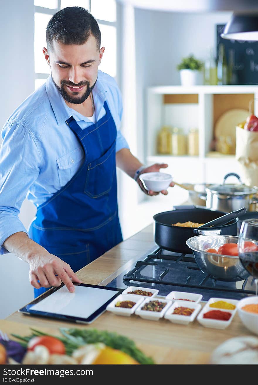 Man preparing delicious and healthy food in the home kitchen