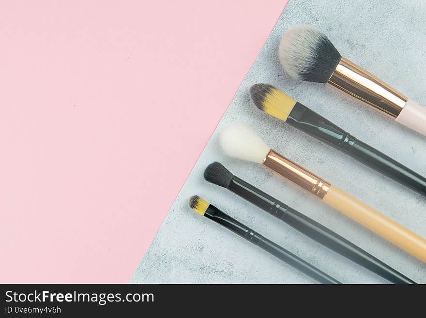 Makeup Brushes Stand On A Concrete Background That Stands On A Pink Table