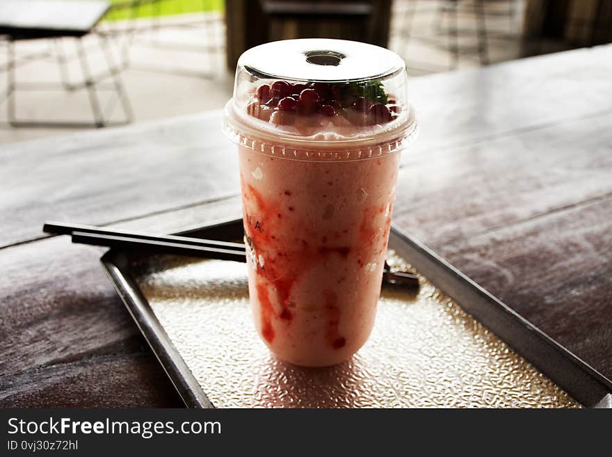 Strawberry yogurt frappe in plastic cup at cafe coffee shop