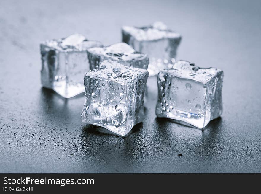 Pyramid of beautiful thawed ice cubes with drops of water