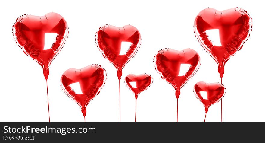 Set of red foil heart shaped balloons on background