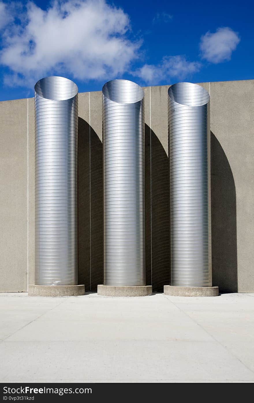 Industrial Pipes Outside Building with Blue Sky Vertical