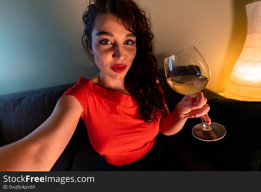 Woman Video Calling to Her Friends At Online Conference and Drinking Wine. Coronavirus Covid-19