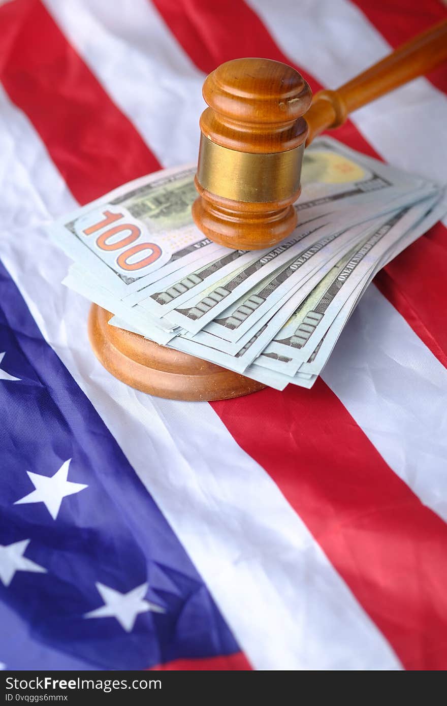 Gavel, cash and flag on table