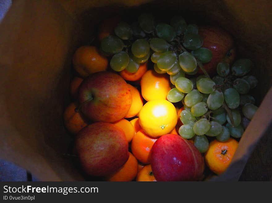 Fresh fruit bag with light in the center. They are apples，oranges，tangerines and grapes. Fresh fruit bag with light in the center. They are apples，oranges，tangerines and grapes.