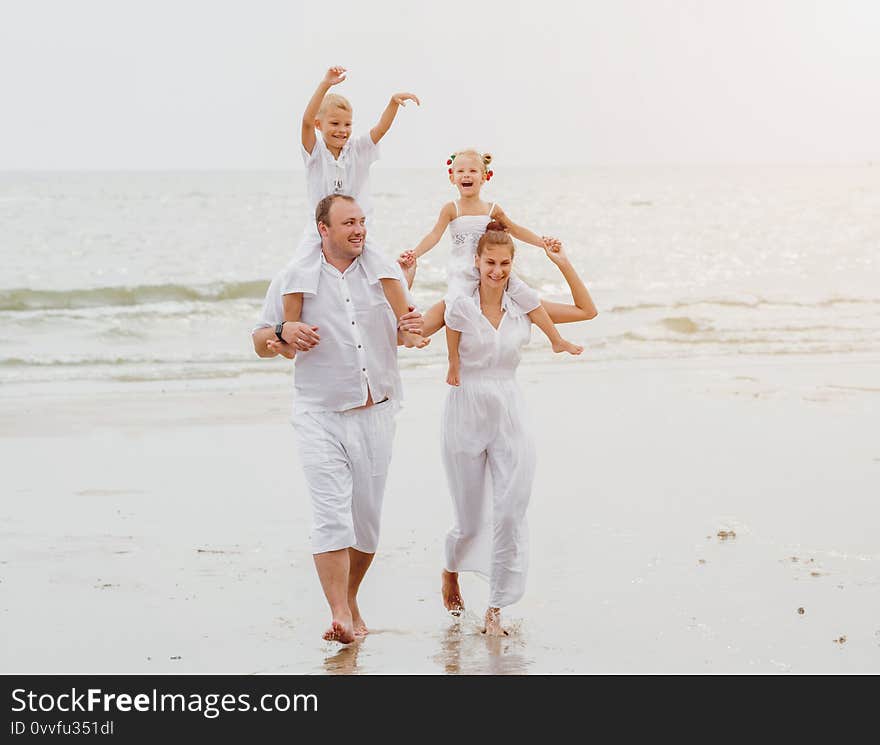 Happy young family on the sunset at the beach. Lifestyle