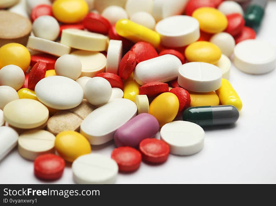 Medication of different colors and forms at white background. Medication of different colors and forms at white background