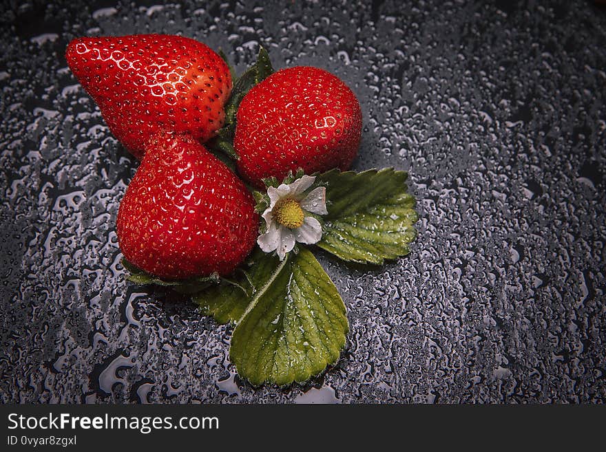 Strawberries on a natural slate base, dark food photograhpy