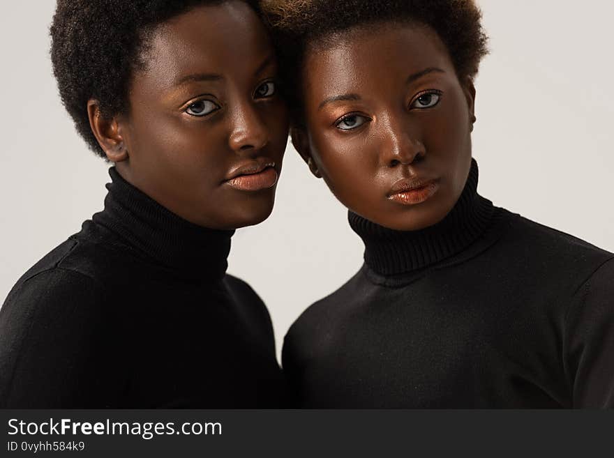 african american women in black turtlenecks isolated on grey. african american women in black turtlenecks isolated on grey