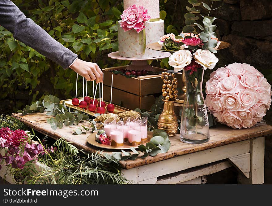 From above of assorted colorful fresh flowers arranged in wooden box near inscription plate with word love. From above of assorted colorful fresh flowers arranged in wooden box near inscription plate with word love