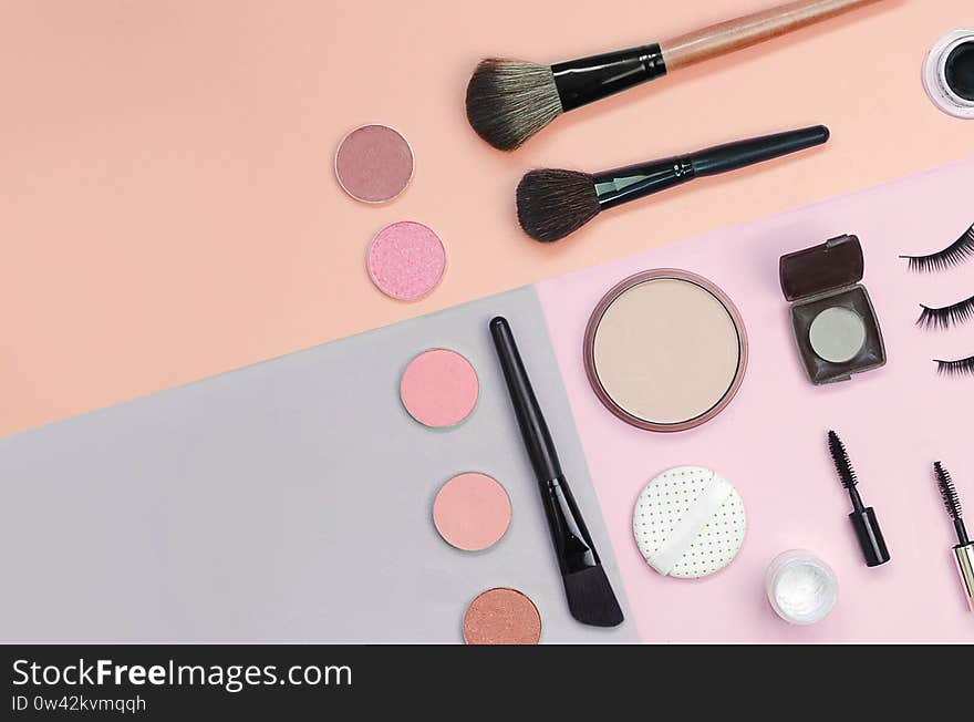 Colorful cosmetics lying on pastel background. Makeup set. Flatlay background for design. Colorful cosmetics lying on pastel background. Makeup set. Flatlay background for design