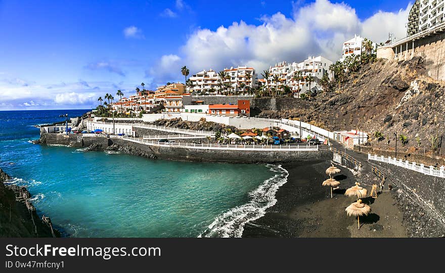 Beautiful Puerto di Santiago village,view with black sand,sea and colorful houses,Tenerife island,Spain. Beautiful Puerto di Santiago village,view with black sand,sea and colorful houses,Tenerife island,Spain.