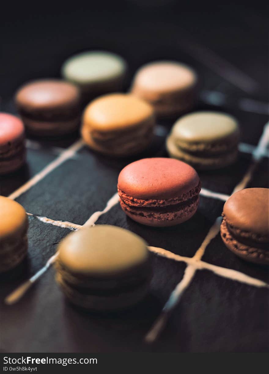 Cookies of multiple colors on a dark surface