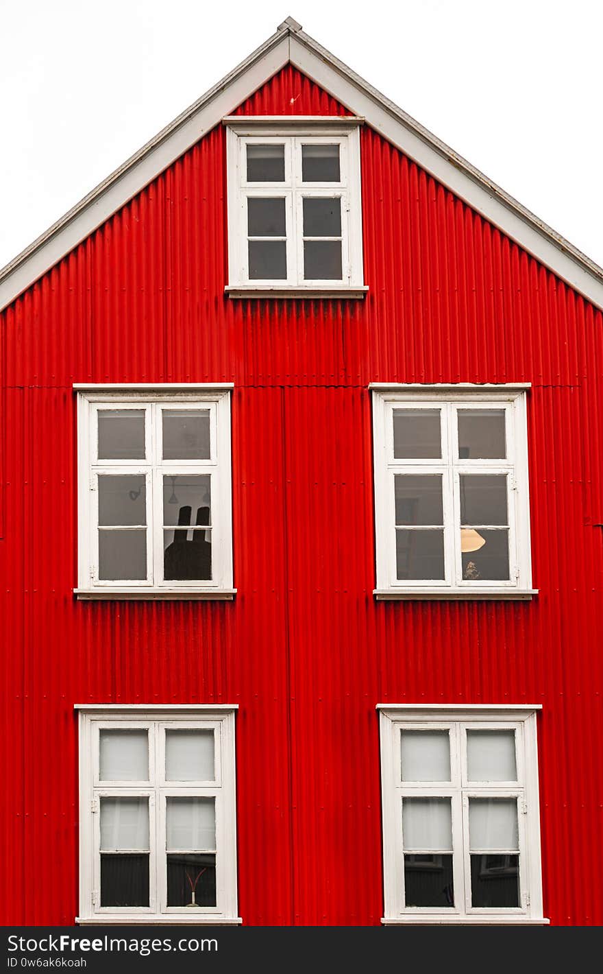 Street shot in Reykjavik center with old historic red sheet metal house