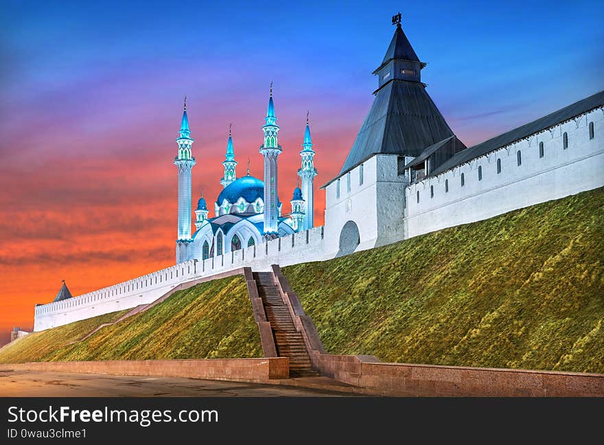 Summer Kul Sharif Mosque and the Transfiguration Tower of the Kazan Kremlin under a red sunset sky in spring evening