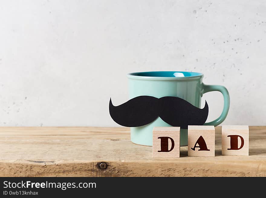 Blue mug with moustache, close up, fathers day concept with title dad on white background, table,  copy space, top view