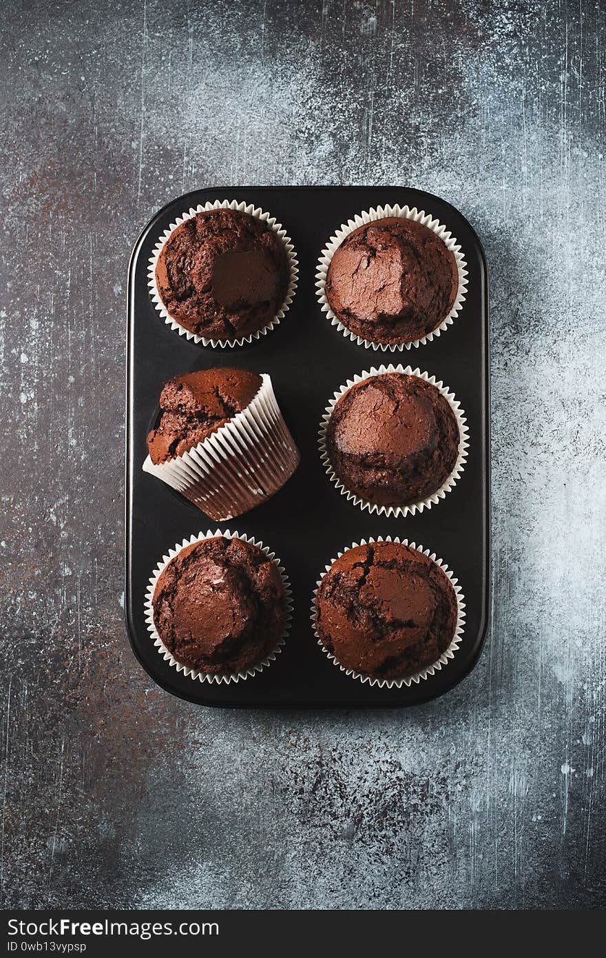 Chocolate brownies cacao muffins flat lay, baking concept, top view, copy space on dark background, vertical