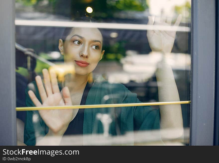 Fashion girl standing in a summer cafe