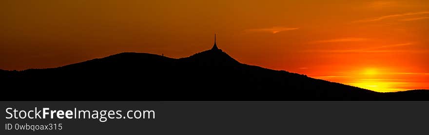 Silhouette of Jested mountain at sunset time, Liberec, Czech Republic. Panoramic shot.