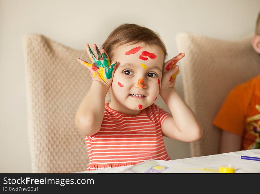 Girl showing painted hands. Hands painted in colorful paints. Education, school, art and painitng concept